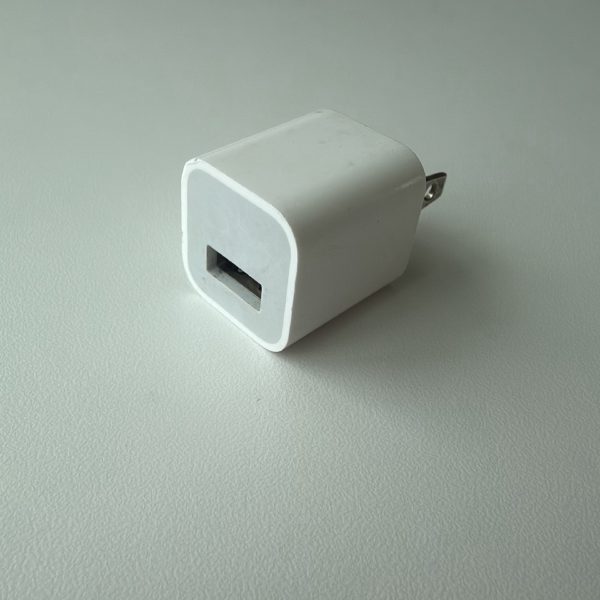 Apple 5W USB Power Adapter, model A1385, the compact cube with a single USB-A port.