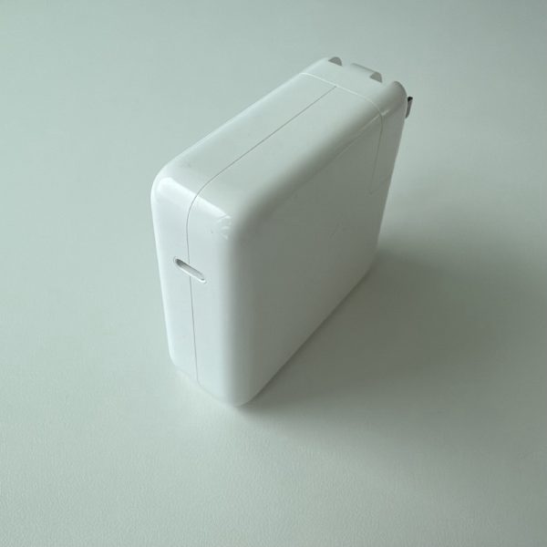 Apple 61W USB-C Power Adapter, model A1947, front view with a single USB-C port.