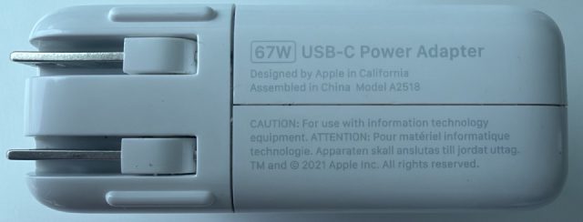 67W USB-C Power Adapter. Designed by Apple in California, Assembled in China. Model A2518. TM and copyright 2021 Apple Inc.
